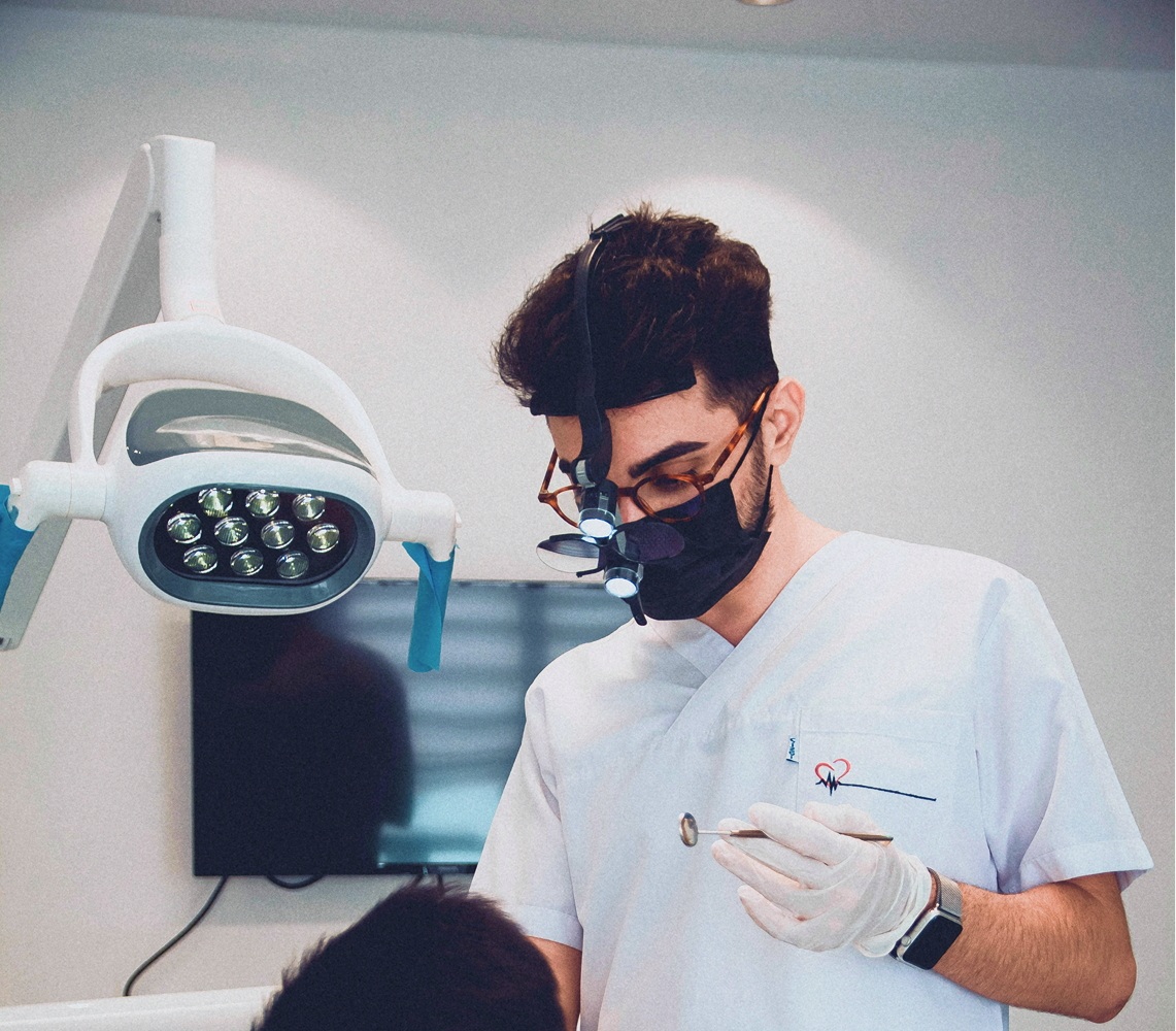 A dentist with a tool in their hand.